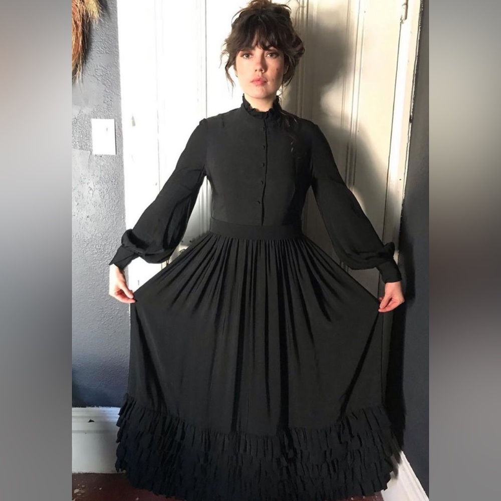 Witchy black silk dress with long sleeves and ruffle details.